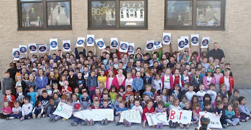 The students of Saint Brendan School are pictured with Fr. John Connolly outside the school during their Boston Strong Dress Down Day on Friday April 26.  Students contributed money to be able to wear Boston Strong colors instead of their uniforms.  “We raised over $2,300.00 which will be donated in its entirety to the Richard Family of Dorchester,” said Maura Burke, the principal at St. Brendan School.